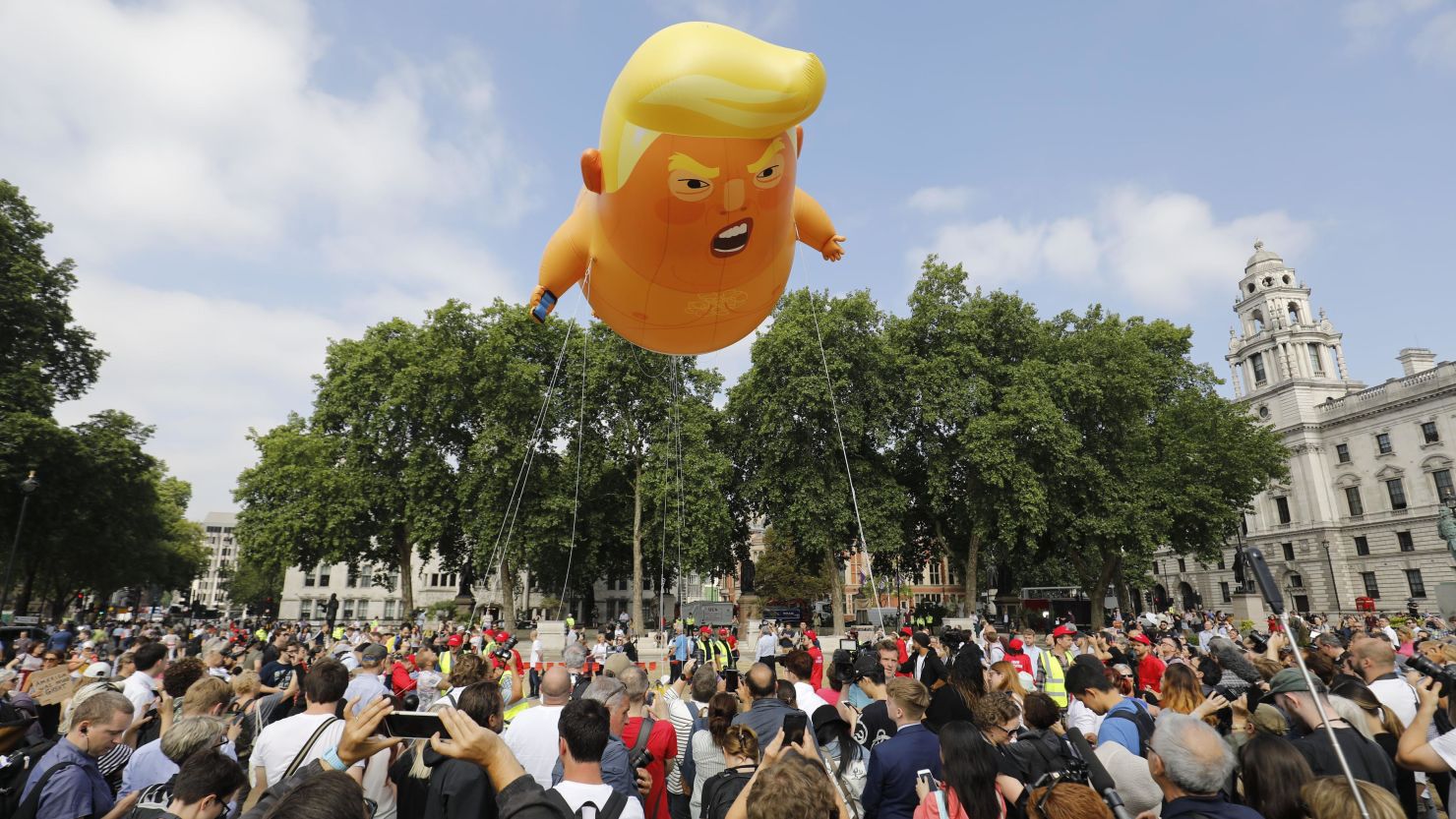 Protesters unveiled a blimp showing Trump as a baby during the visit.