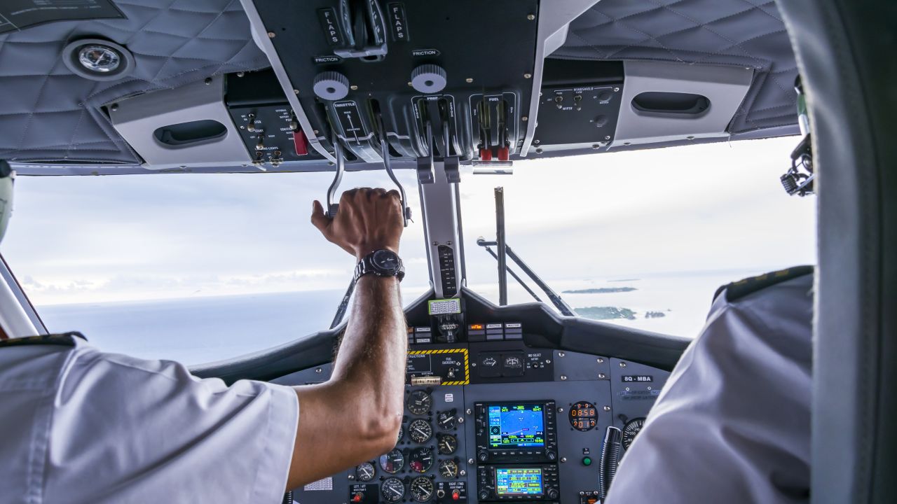Interior details of a water plane with pilot and co pilot on board while flying. The photography is a demonstration of team work.