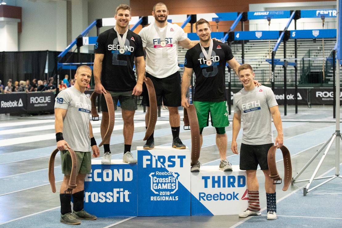 Mat Fraser stands atop the podium after a dominant performance at the CrossFit East Regionals.