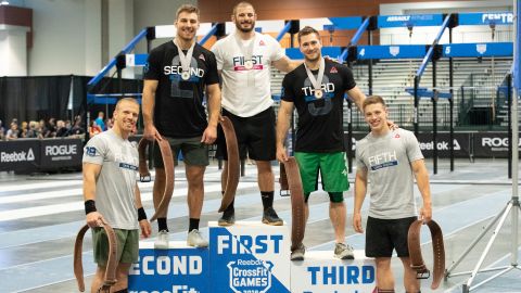 Mat Fraser stands atop the podium after a dominant performance at the CrossFit East Regionals.