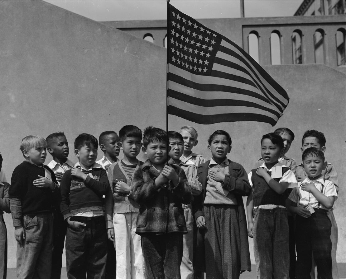 "San Francisco, California. Flag of allegiance pledge at Raphael Weill Public School, Geary and Buchanan Streets. Children in families of Japanese ancestry were evacuated with their parents and will be housed for the duration in War Relocation Authority centers where facilities will be provided for them to continue their education." (1942)
