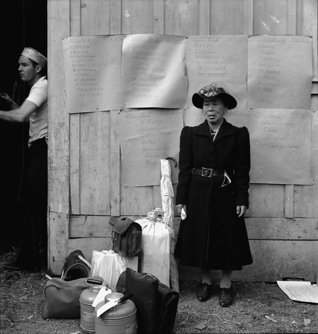 "Centerville, California. This evacuee stands by her baggage as she waits for evacuation bus. Evacuees of Japanese ancestry will be housed in War." (1942) 