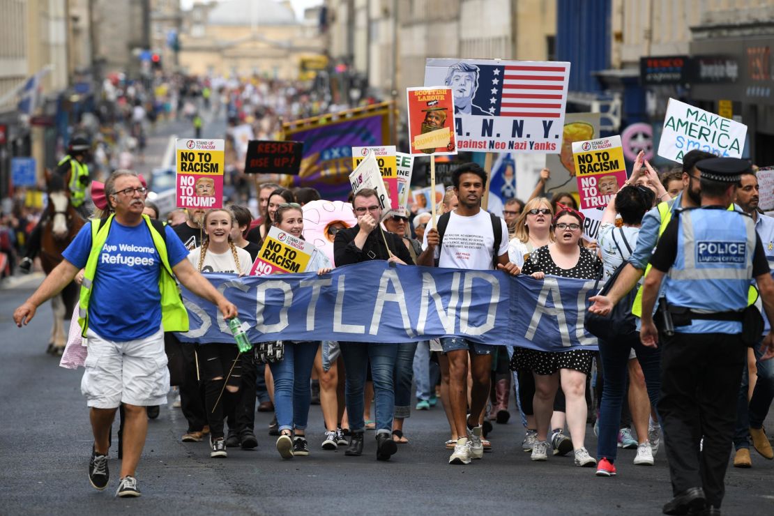 People march holding anti-Trump signs on Saturday in Edinburgh, Scotland.