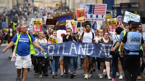 People march holding anti-Trump signs on Saturday in Edinburgh, Scotland.