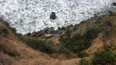 Emergency personnel used ropes to pull Angela Hernandez up from the bottom of the cliff.
