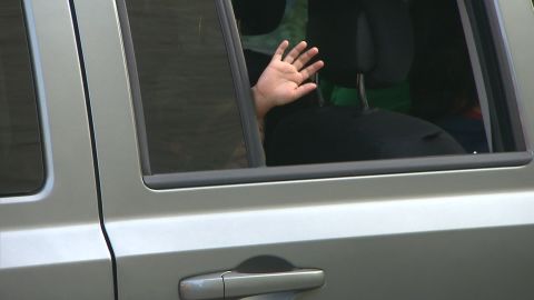 Jostin waves from a car window after he was reunited with his father, Eris Ramirez, on Saturday, June 14. The pair left to stay with friends in upstate New York as they await their asylum hearing.