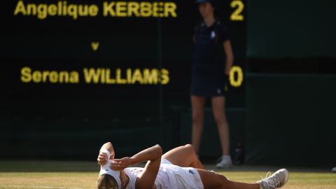 Kerber falls to the floor after her win