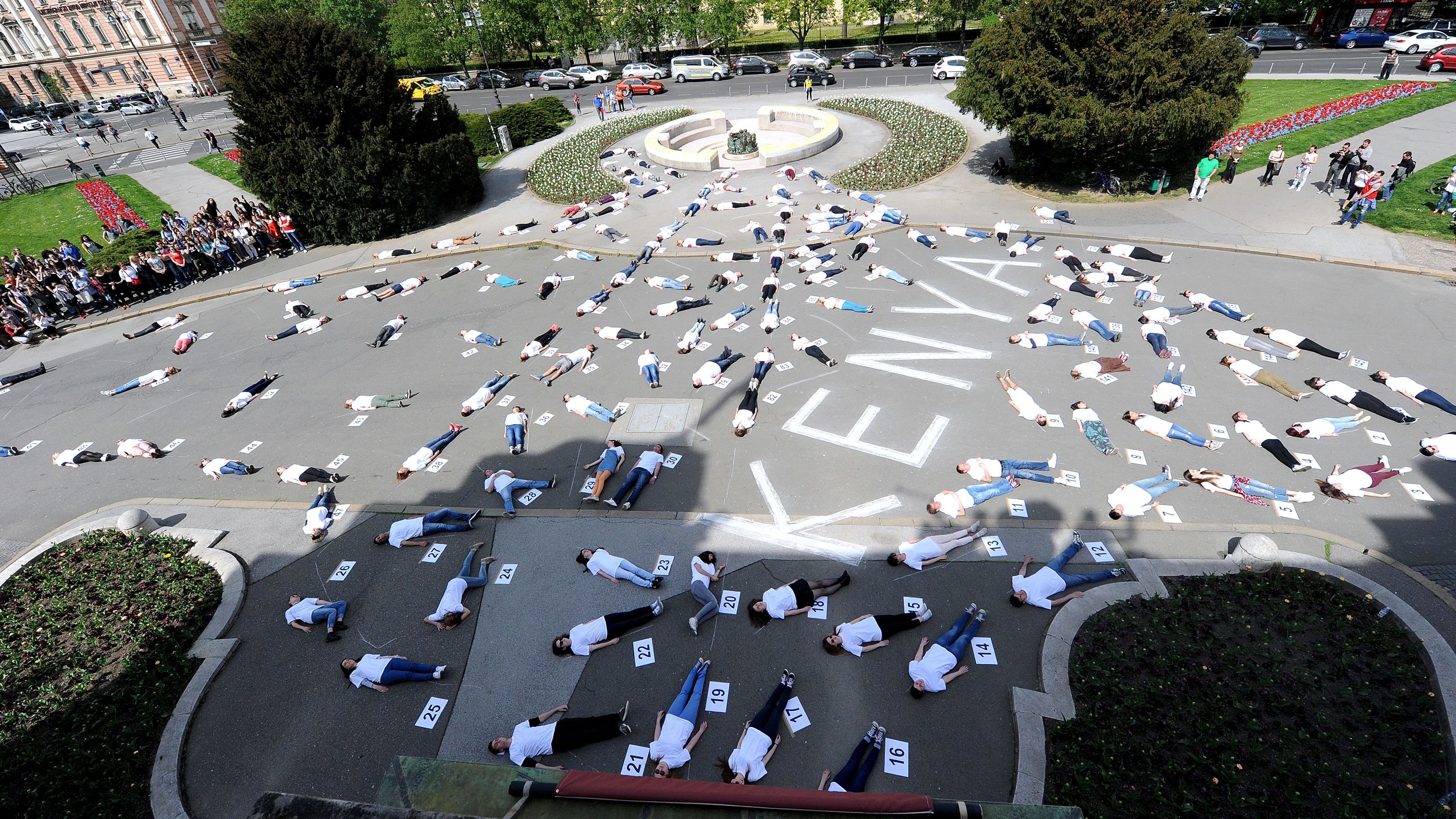 147 Croatian students lie on the ground for 147 seconds in front of the Zagreb University building in Zagreb, Croatia, on April 16, 2015, to voice solidarity with the victims of an attack on Garissa University. 