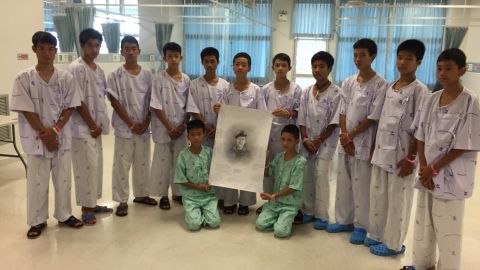 The Wild Boars soccer team hold a portrait of ex-Navy SEAL Saman Kunan.