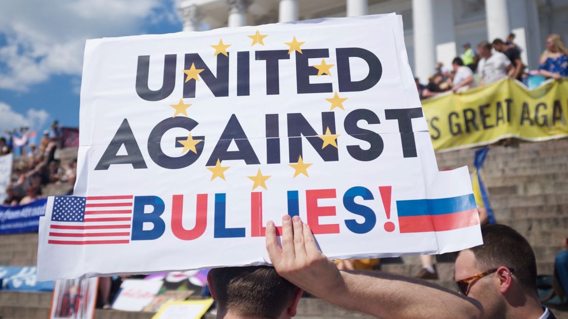 Protesters carried signs in Senate Square, protesting the policies of Donald Trump and Vladimir Putin.