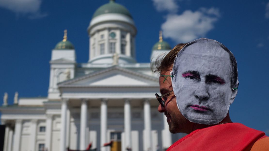 A protester wears a Vladimir Putin mask at the protest in Helsinki's Senate Square.