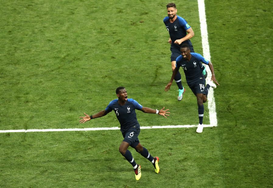 Paul Pogba, bottom, runs to the corner after scoring France's third goal.