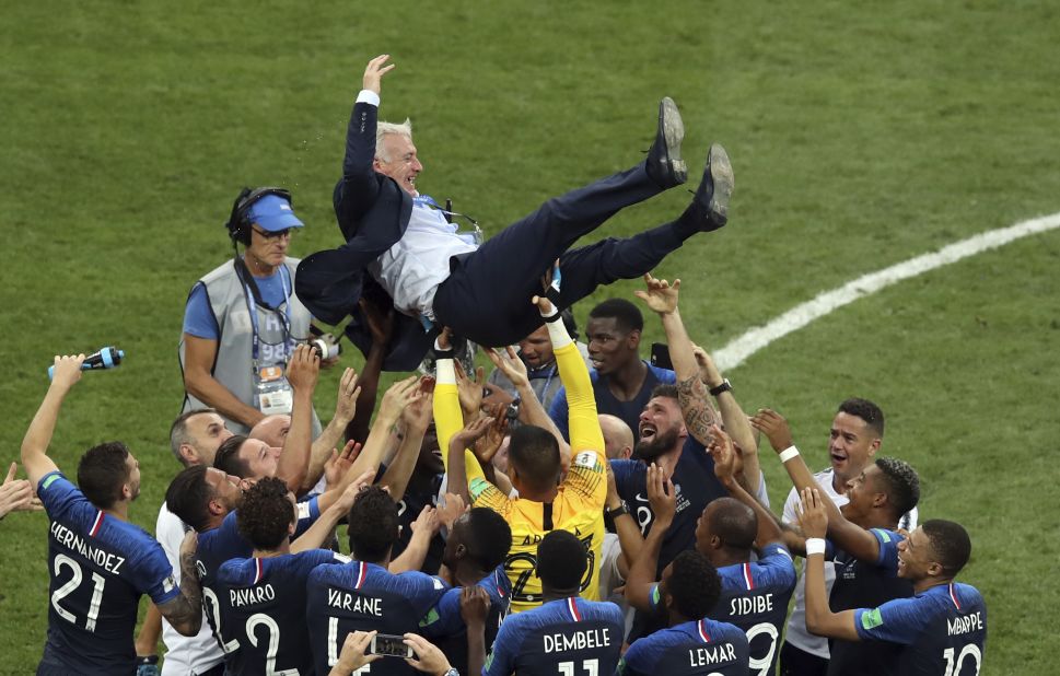 France manager Didier Deschamps is lifted by his players after the victory. Deschamps was also a player on the 1998 French team that won the World Cup.