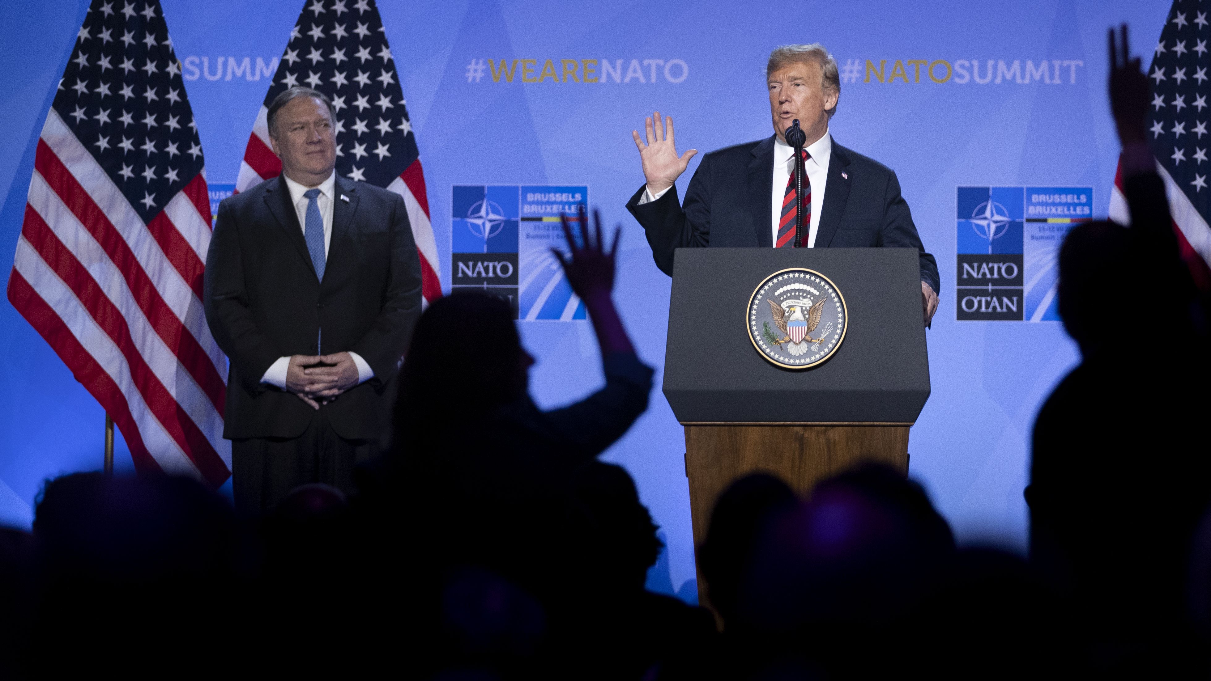 U.S. President Donald Trump gestures besides U.S. Secretary of State Mike Pompeo during a news conference at the 2018 NATO Summit at NATO headquarters on July 12, 2018 in Brussels, Belgium. 