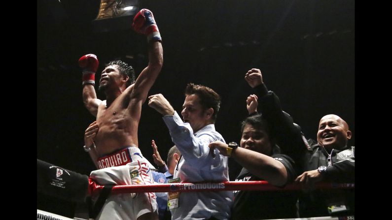 Manny Pacquiao, left, celebrates after defeating Lucas Matthysse during their WBA World welterweight title bout in Kuala Lumpur, Malaysia, on Sunday, July 15. Filipino boxing legend Pacquiao clinched his 60th victory Sunday with a seventh-round knockout of Matthysse, his first stoppage in nine years, that will help revive his career. 