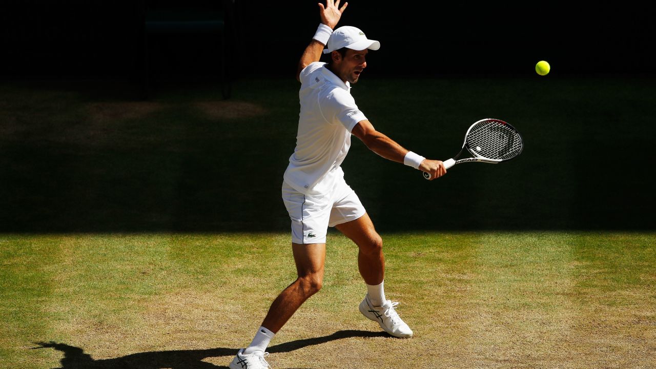 Novak Djokovic strikes a backhand during the Wimbledon final against Kevin Anderson.