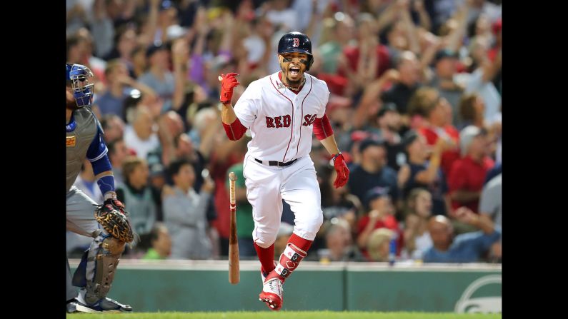 Boston Red Sox player Mookie Betts screams as he runs to first base after hitting a grand slam in the fourth inning. The Boston Red Sox hosted the Toronto Blue Jays in a regular season MLB baseball game in Boston on Thursday, July 12. 
