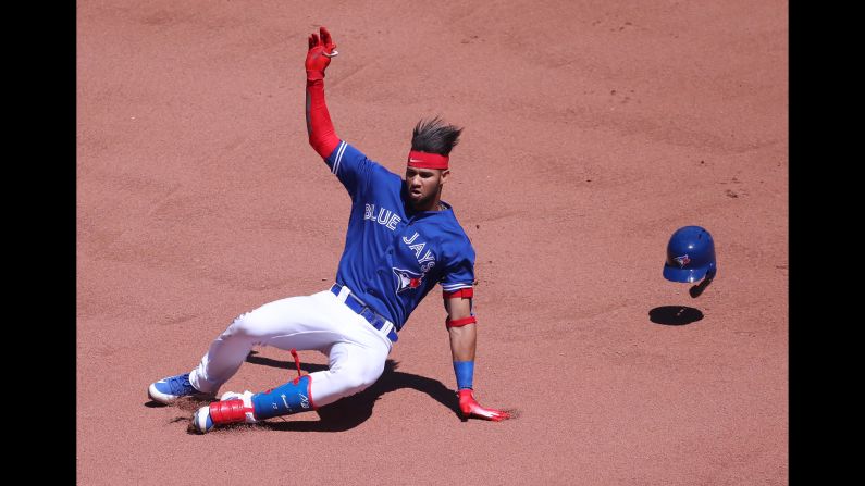 Lourdes Gurriel Jr. of the Toronto Blue Jays slides into second base as he hits a double in the seventh inning during an MLB game against the New York Yankees on Sunday, July 8, in Toronto, Canada. <br />
