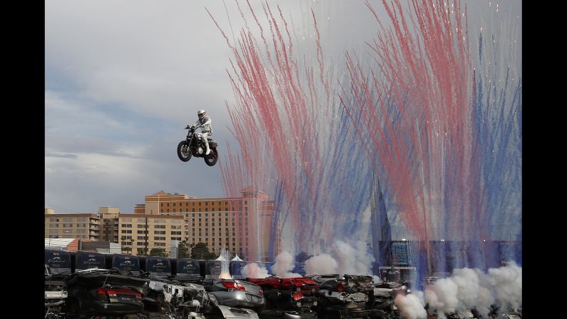 Travis Pastrana jumps a row of crushed cars on a motorcycle, Sunday, July 8, in Las Vegas. Pastrana recreated three of Evel Knievel's iconic motorcycle jumps on Sunday, including the leap over the fountains of Caesars Palace that left Knievel with multiple fractures and a severe concussion.<br />