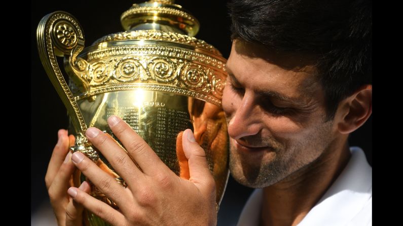 Novak Djokovic poses with the winners' trophy after beating Kevin Anderson in the final match of the Wimbledon Championships on Sunday, July 15.