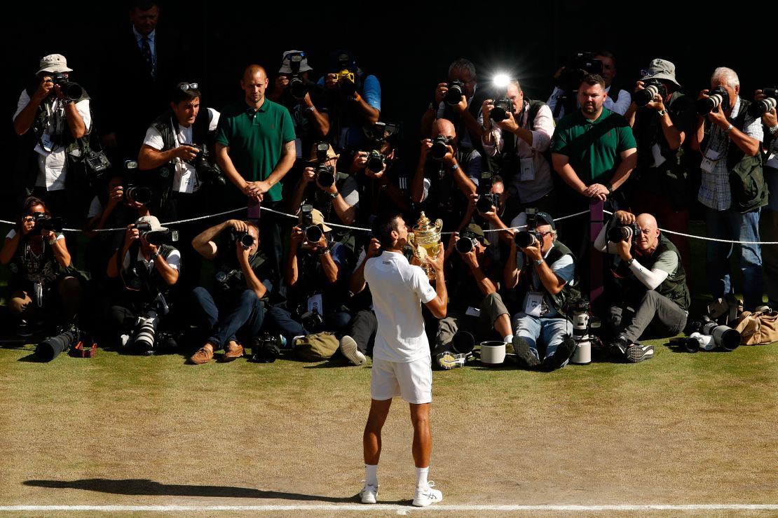 Novak Djokovic kisses the trophy after winning his fourth Wimbledon title. 