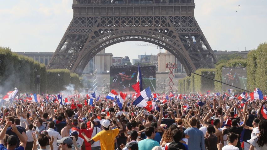 TOPSHOT - France supporters cheer on the fan zone as they watch the Russia 2018 World Cup final football match between France and Croatia, on the Champ de Mars in Paris on July 15, 2018. (Photo by JACQUES DEMARTHON / AFP)        (Photo credit should read JACQUES DEMARTHON/AFP/Getty Images)