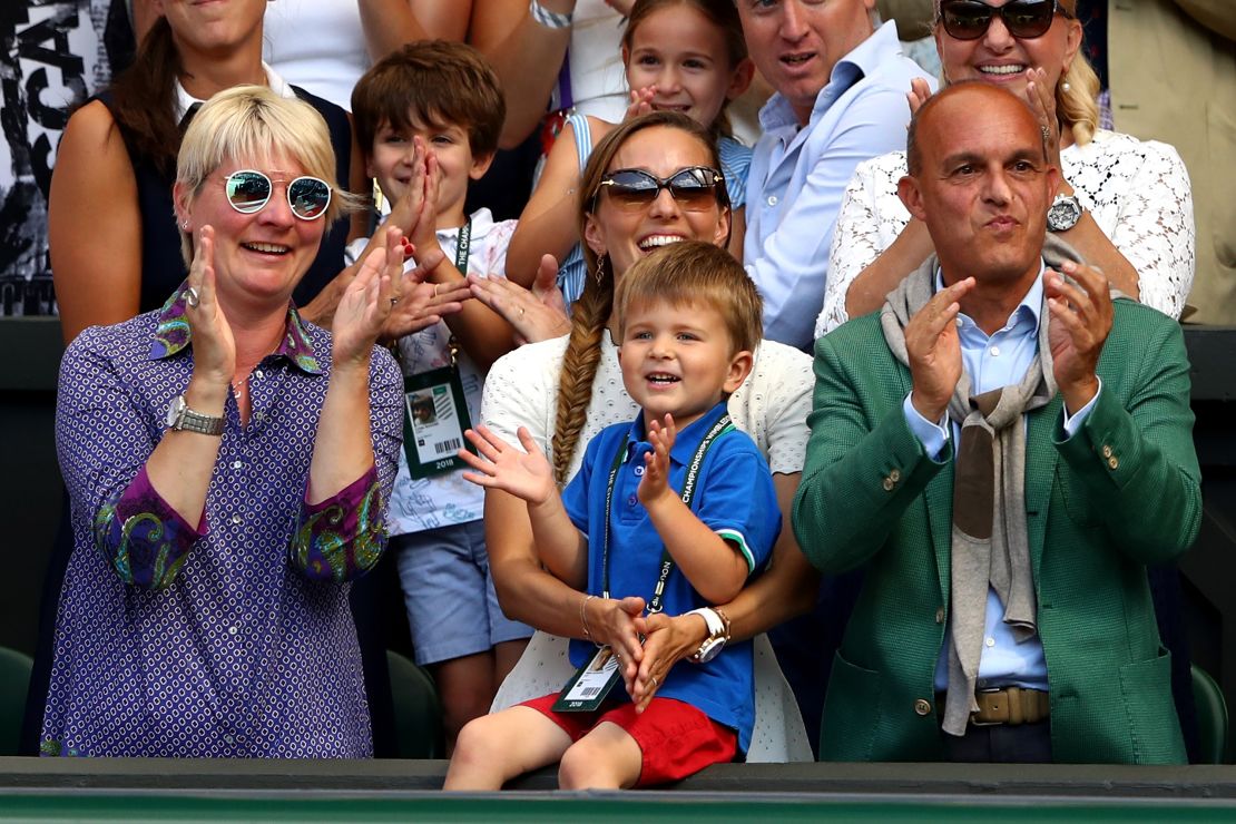 Novak Djokovic's three-year-old son Stefan watches his Dad hoist the Wimbledon trophy. 