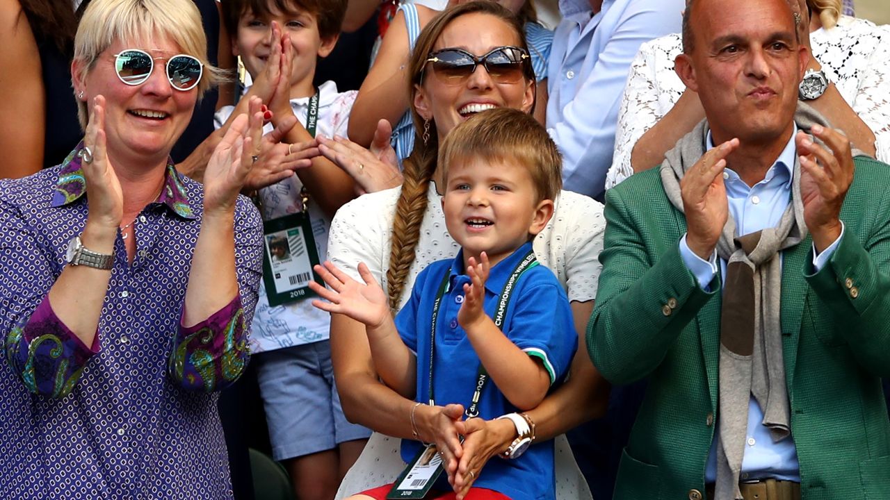 Novak Djokovic's three-year-old son Stefan watches his Dad hoist the Wimbledon trophy.
