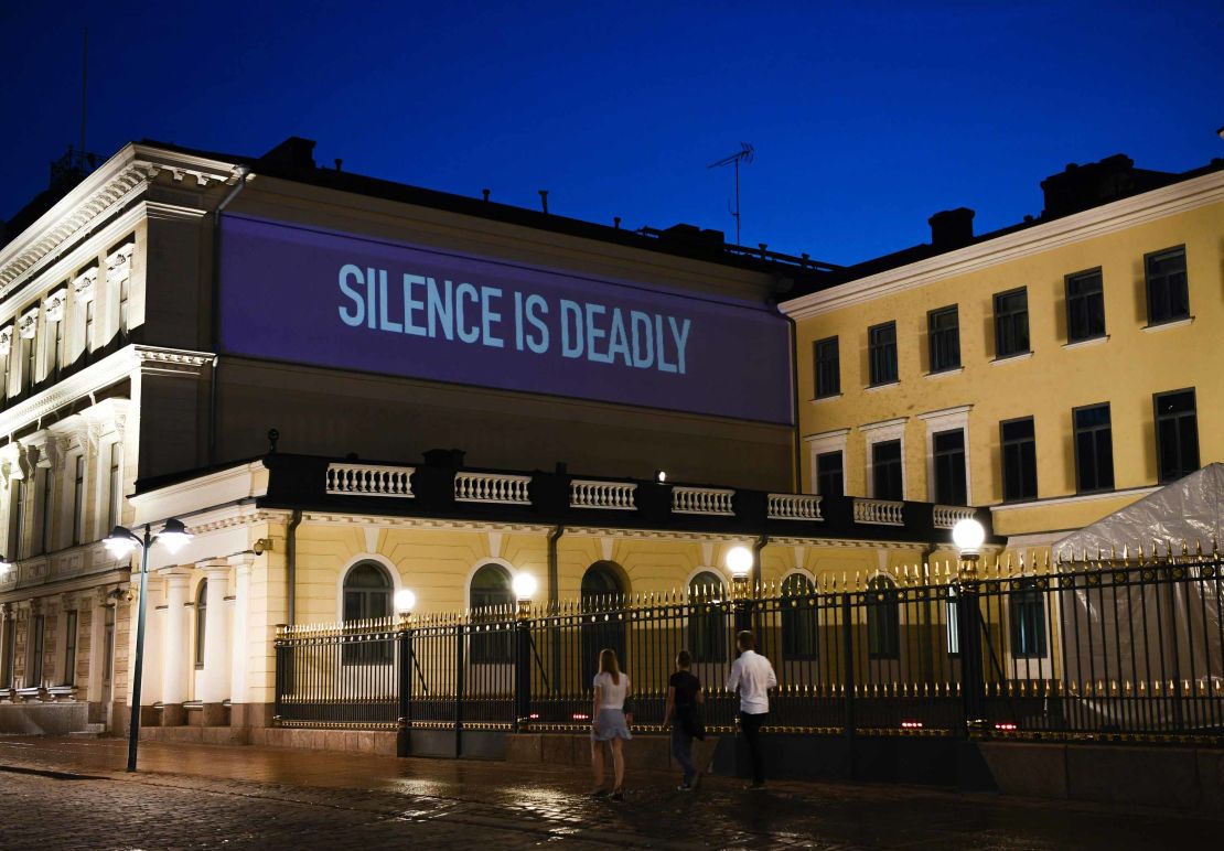 A sentence reading Silence is Deadly is projected on the presidential palace in Helsinki ahead of the summit.