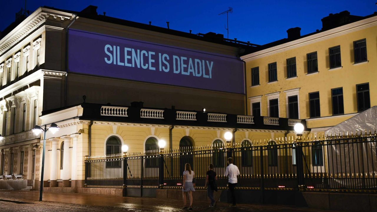 A sentence reading Silence is Deadly is projected on the presidential palace in Helsinki ahead of the summit.