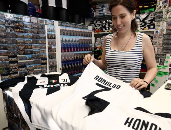 Juventus is already reaping commercial rewards from Ronaldo's signing, with a reported estimate of 520,000 replica jerseys flying off the shelves and online. This photo shows a saleswoman folding the famous No. 7 jersey at Juventus' flagship Turin store on July 11, the day after the deal was announced. 