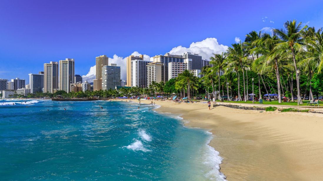 <strong>October in Honolulu, Hawaii:</strong> The sun rises over Waikiki Beach in Honolulu, which is on the Hawaiian island of Oahu. October visitors may be able to find good airline deals before the holiday crowds start to fly in.