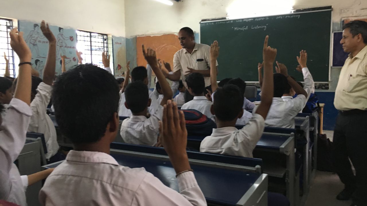 Sunil Kumar Joon, a teacher at a New Delhi government school speaks with his students Monday.