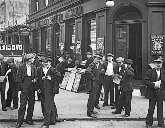 Men congregate outside a pub in Canning Town, a neighborhood in east London. 