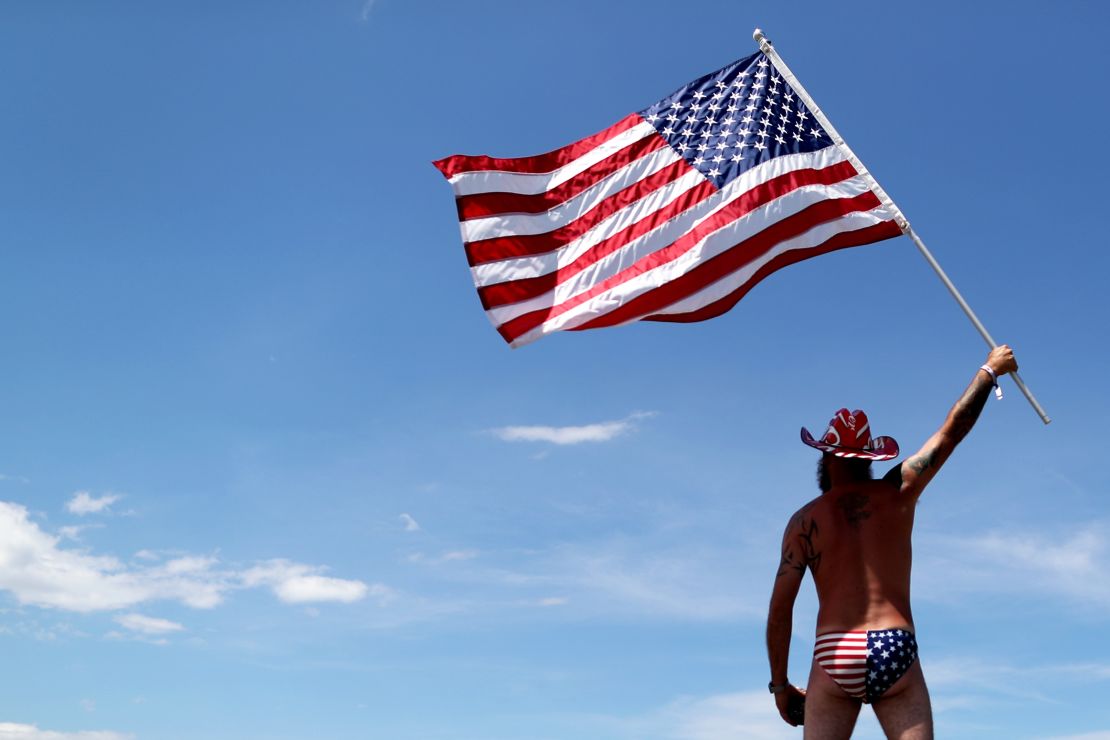 DAYTONA BEACH, FL - JULY 07:  A fan waves an American Flag in the infield prior to the Monster Energy NASCAR Cup Series Coke Zero Sugar 400 at Daytona International Speedway on July 7, 2018 in Daytona Beach, Florida.  (Photo by Sean Gardner/Getty Images)