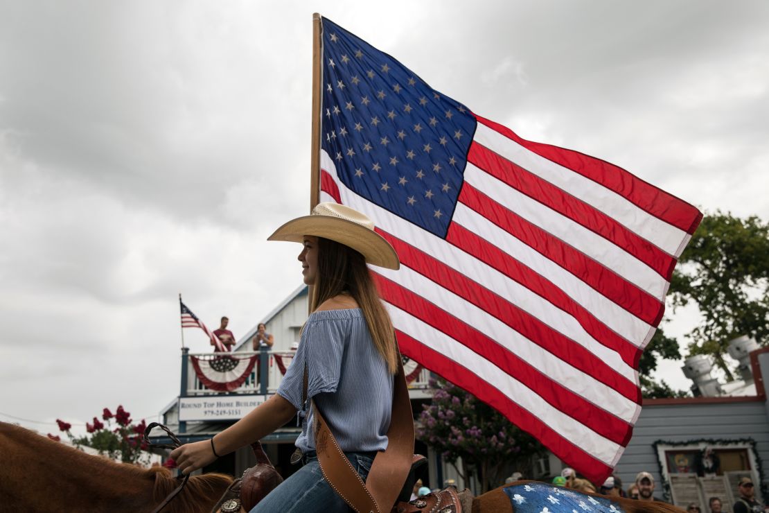 ROUND TOP, TX - JULY 04: Kaitlyn Tarnoswki, 14, carries an American flag while riding a horse during the 168th annual Round Top Fourth of July Parade on July 4, 2018 in Round Top, Texas. The Round Top community's Fourth of July celebration started in 1851 and is known as the longest running Fourth of July celebration west of the Mississippi. (Photo by Tamir Kalifa/Getty Images)