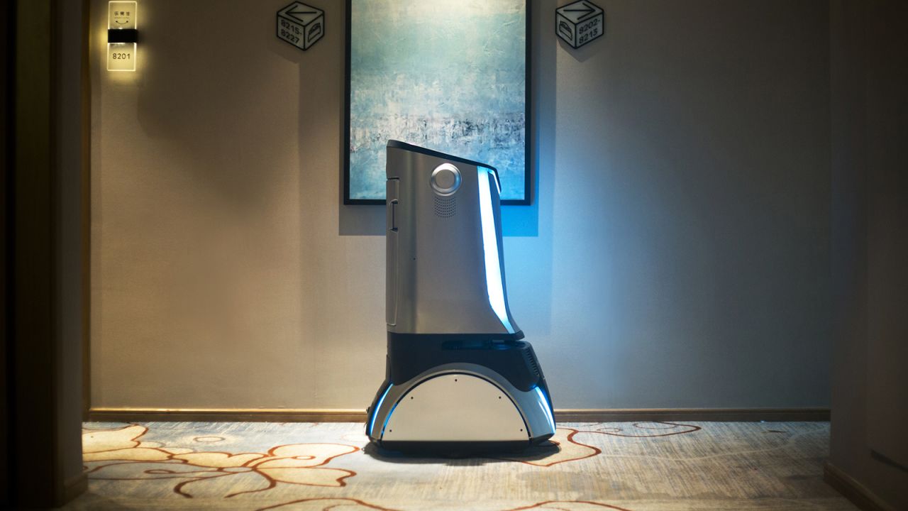 A robot stands by to guide guests to find their rooms.