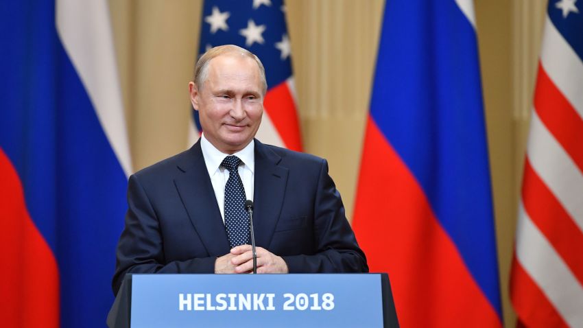 Russia's President Vladimir Putin smiles during a joint press conference with US President after a meeting at the Presidential Palace in Helsinki, on July 16, 2018. - The US and Russian leaders opened an historic summit in Helsinki, with Donald Trump promising an "extraordinary relationship" and Vladimir Putin saying it was high time to thrash out disputes around the world. (Photo by Yuri KADOBNOV / AFP)