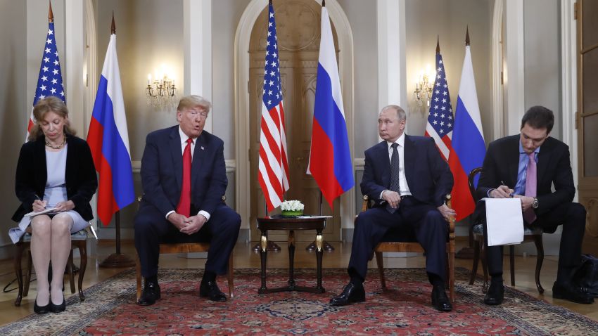 U.S. President Donald Trump, second from left, gives a statement as Russian President Vladimir Putin, second from right, looks on and translators take notes at the beginning of a meeting at the Presidential Palace in Helsinki, Finland, Monday, July 16, 2018. (AP Photo/Pablo Martinez Monsivais)