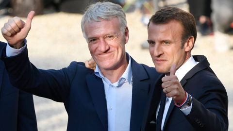 Macron poses with French coach Didier Deschamps (L) in Paris. 