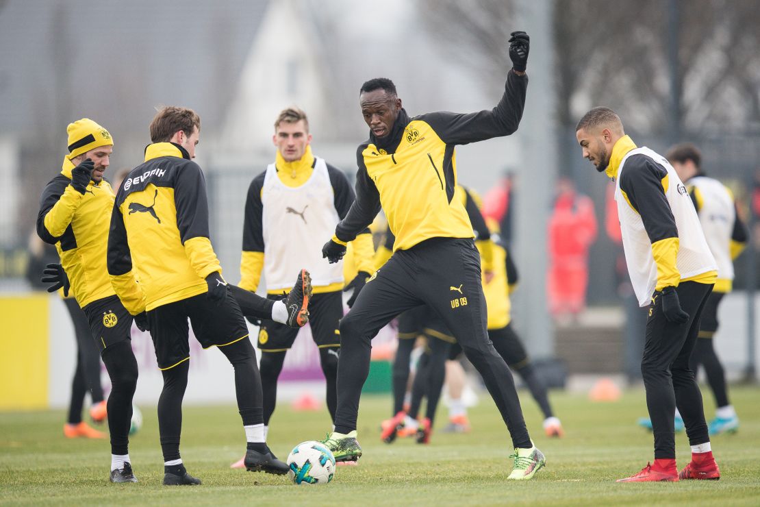 Usain Bolt warms up with Dortmund players, including star player Mario Gotze.