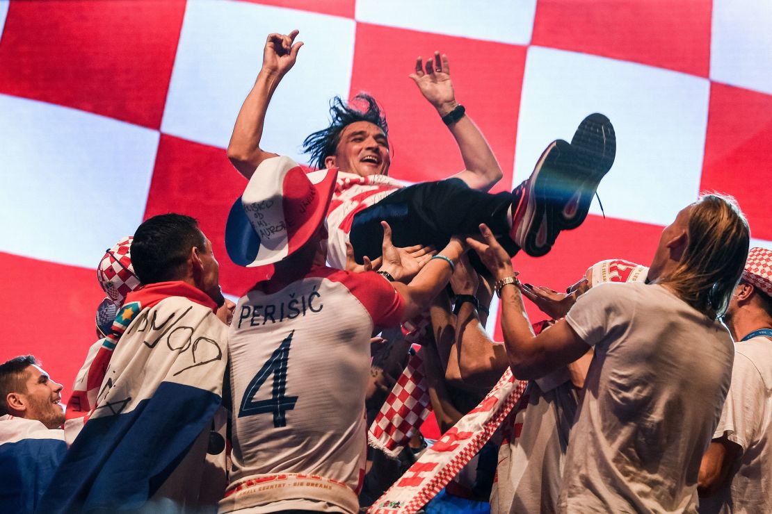 Croatian coach Zlatko Dalic is tossed  into the air by his  players during the welcoming ceremony.