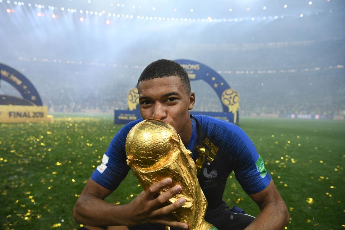 Kylian Mbappe kisses the World Cup trophy after France's win over Croatia.