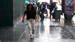 People take cover in Midtown New York on July 17, 2018 as a sudden storm hit the area with flash food warning in the tri-state area. Timothy A. Clary/AFP/Getty Images