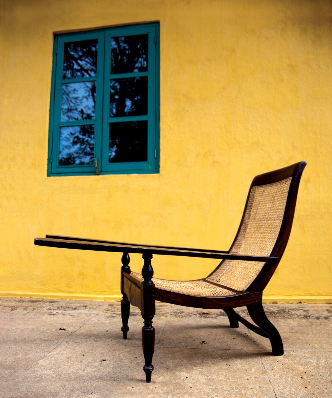 The planter's chair is thought to have been imported to India from Sri Lanka by the British. It has become a staple of the county, with its cane weaving much more suitable to the climate than a sofa.