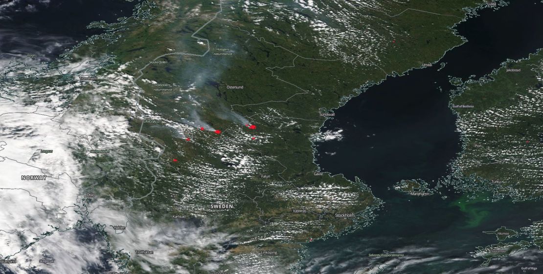 NASA MODIS satellite image shows multiple large fires (in red) burning in central and southern Sweden on Tuesday, spreading smoke for hundreds of kilometers across Scandinavia.