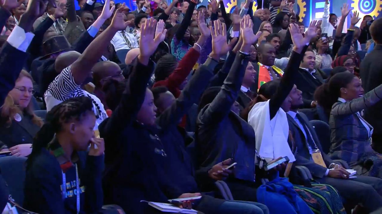 The enthusiastic crowd raises their hands in a bid to ask Obama a question on Wednesday.