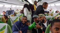 Passengers pose for a selfie picture inside an Ethiopian Airlines flight who departed from the Bole International Airport in Addis Ababa, Ethiopia, to Eritrea's capital Asmara on July 18, 2018. - The first commercial flight to Eritrea in two decades departed on July 18, 2018 from Addis Ababa after the two nations ended their bitter conflict in a whirlwind peace process. (Photo by Maheder HAILESELASSIE TADESE / AFP)        (Photo credit should read MAHEDER HAILESELASSIE TADESE/AFP/Getty Images)