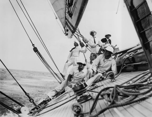 Pictured here in 1935 is the crew of 'Candida' steering the yacht along a heavily inclined wave during a race.