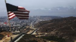 SAN DIEGO, CA - JULY 16:  An American flag flies along a section of the U.S.-Mexico border fence on July 16, 2018 in San Diego, California. The entire Southwest border saw 34,114 U.S. Border Patrol apprehensions in the month 